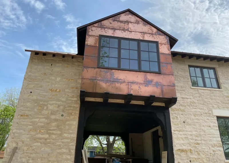 Copper metal panel facade on a stone building for Skylight Installation in Clearfield